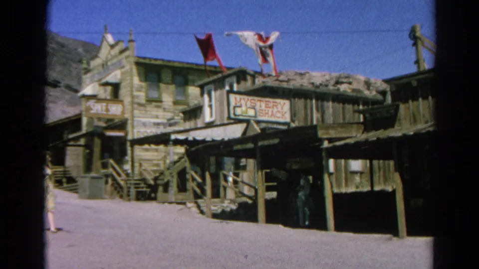 1966 Silver Lake footage shows rustic wooden storefronts, shop signs, flags, and a woman at the edge of the street.