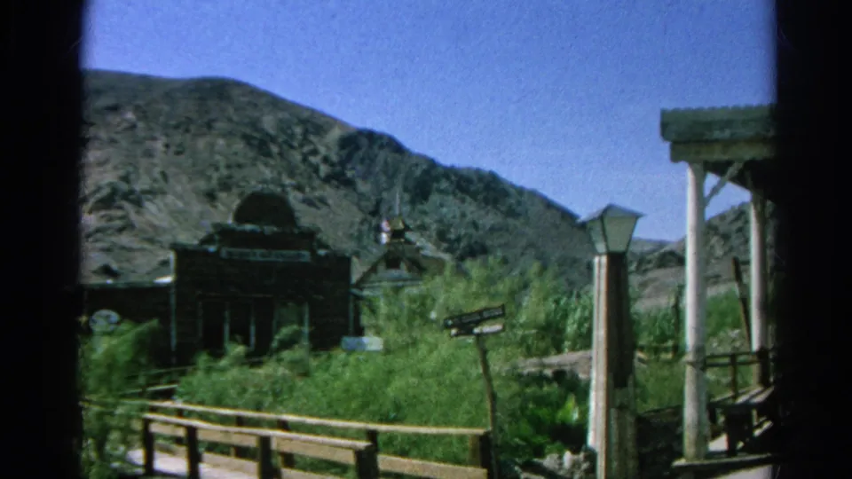 Final 1966 Silver Lake, California frame showing the Western-town church-like building, signs, porch posts, brush, and hillside.