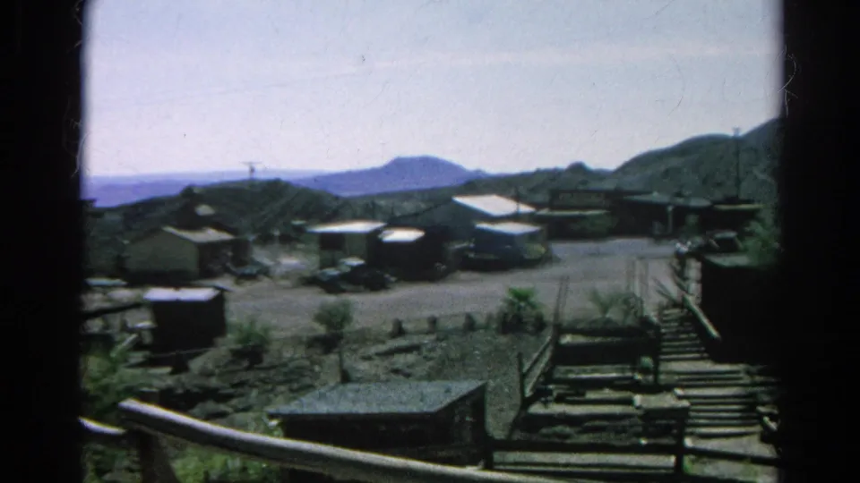 Mid-1960s Silver Lake hillside neighborhood view with homes, cars, wooden railings, steps, and distant hills.