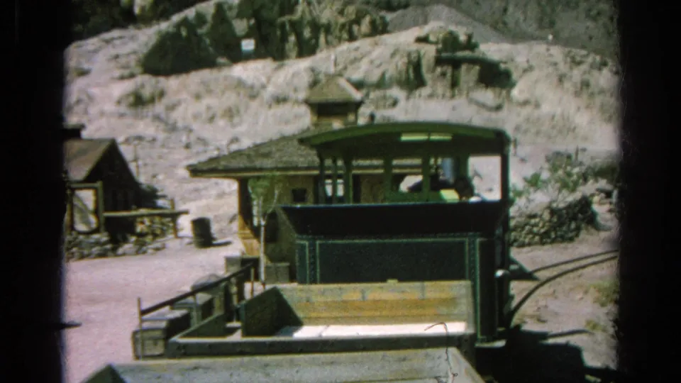 The Silver Lake footage shows a green train or tram car, platform railings, and rustic structures against pale rocky hills.