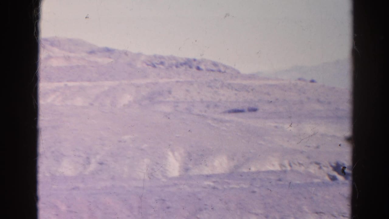 1966 8mm home-movie frame of arid hills and distant ridges in the Silver Lake, California region, with soft focus and film wear.