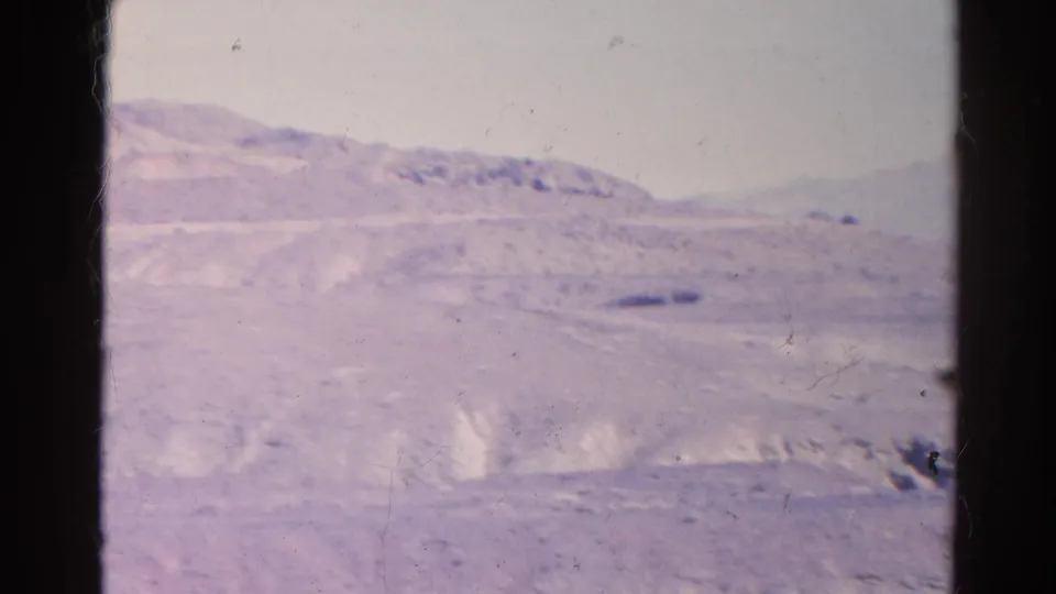 1966 8mm home-movie frame of arid hills and distant ridges in the Silver Lake, California region, with soft focus and film wear.
