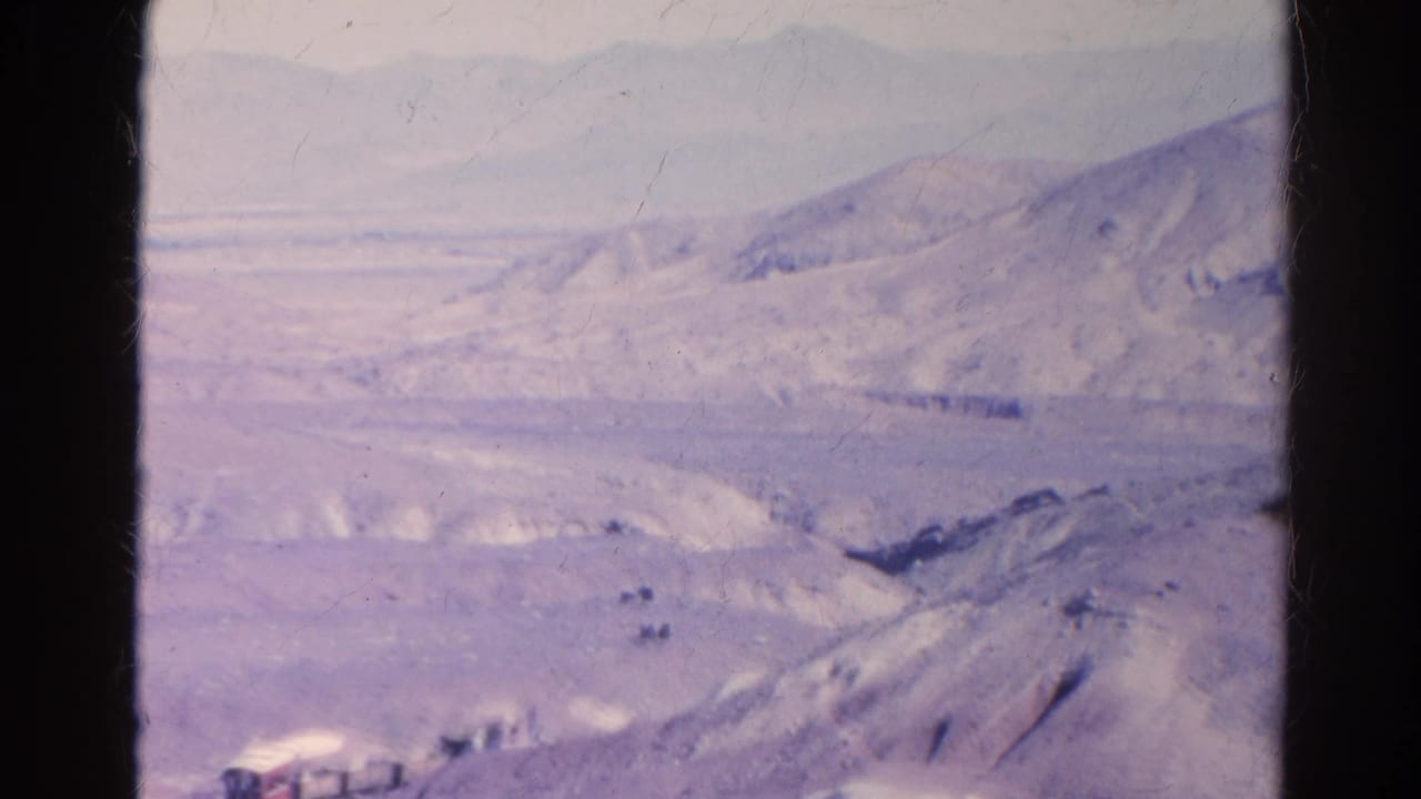1966 Silver Lake, California frame with pale desert slopes, a wide valley, and soft distant mountain ridges.