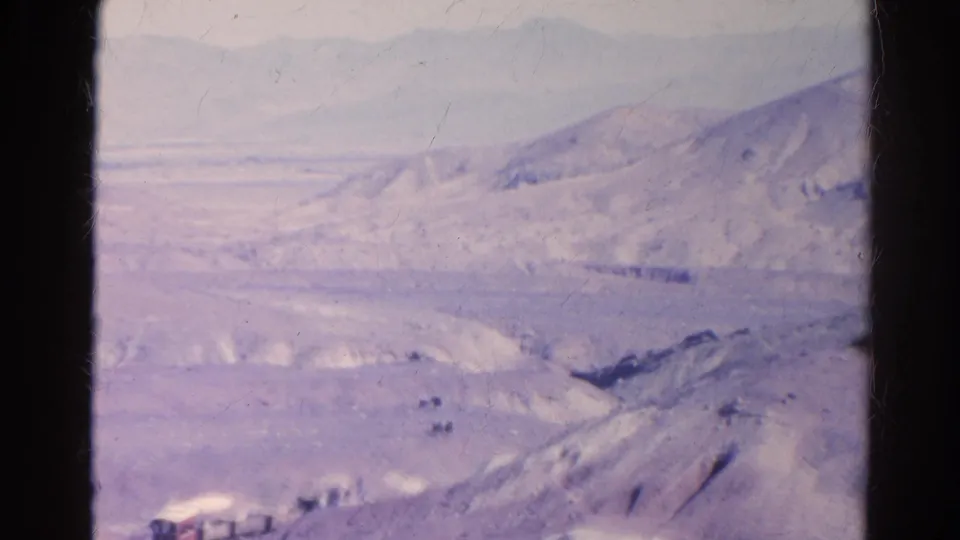 1966 Silver Lake, California frame with pale desert slopes, a wide valley, and soft distant mountain ridges.