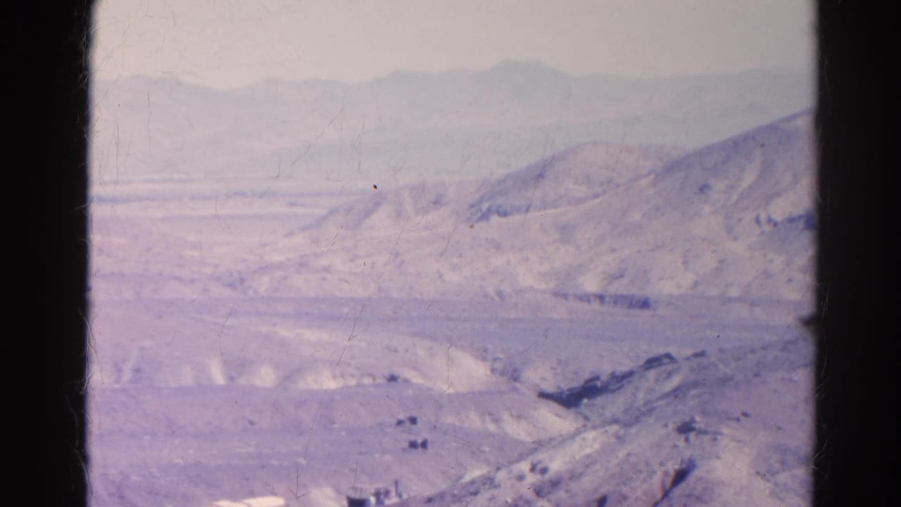 1966 Silver Lake, California frame showing a quiet arid valley, pale hills, and distant mountains in soft 8mm color.