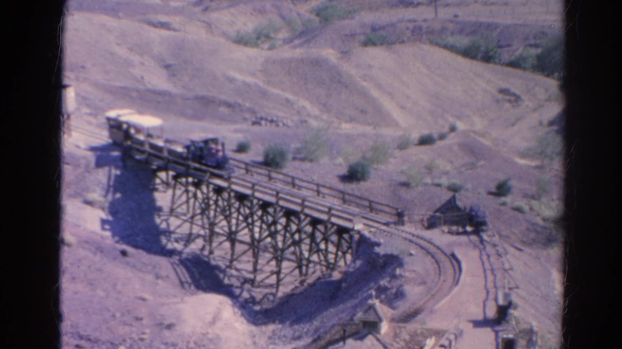 Final 1966 Silver Lake frame showing the train on the elevated wooden trestle, with arid hills and trackside structures in view.