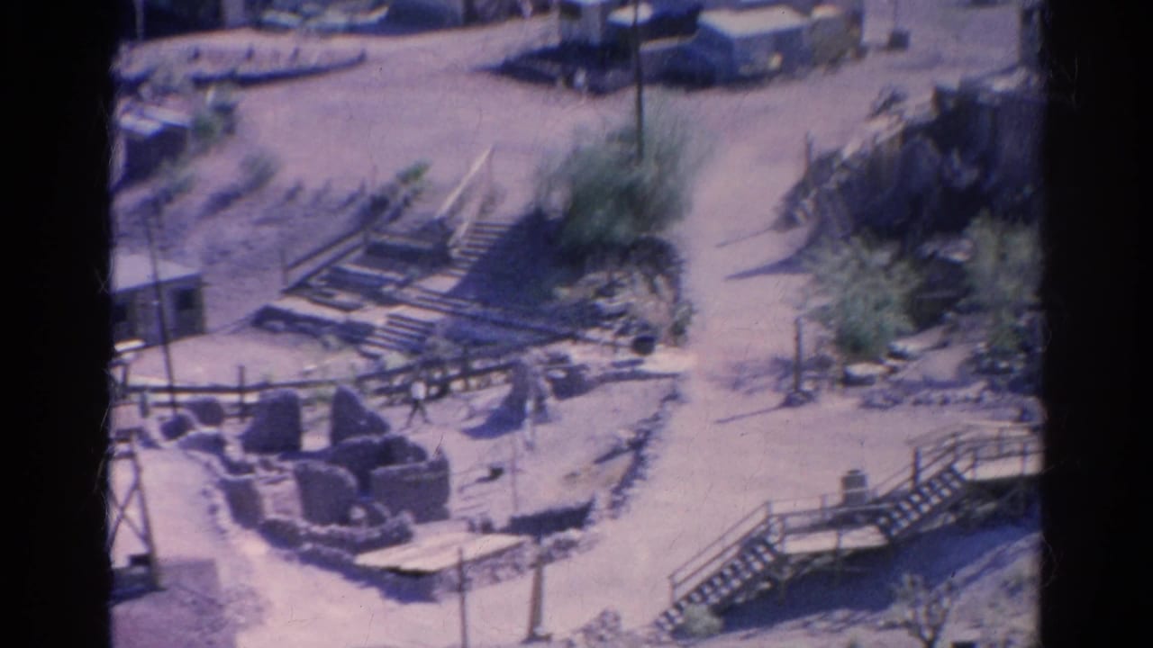 1966 Silver Lake home-movie view of a desert compound with stairs, railings, small buildings, sandy roads, and sparse vegetation.