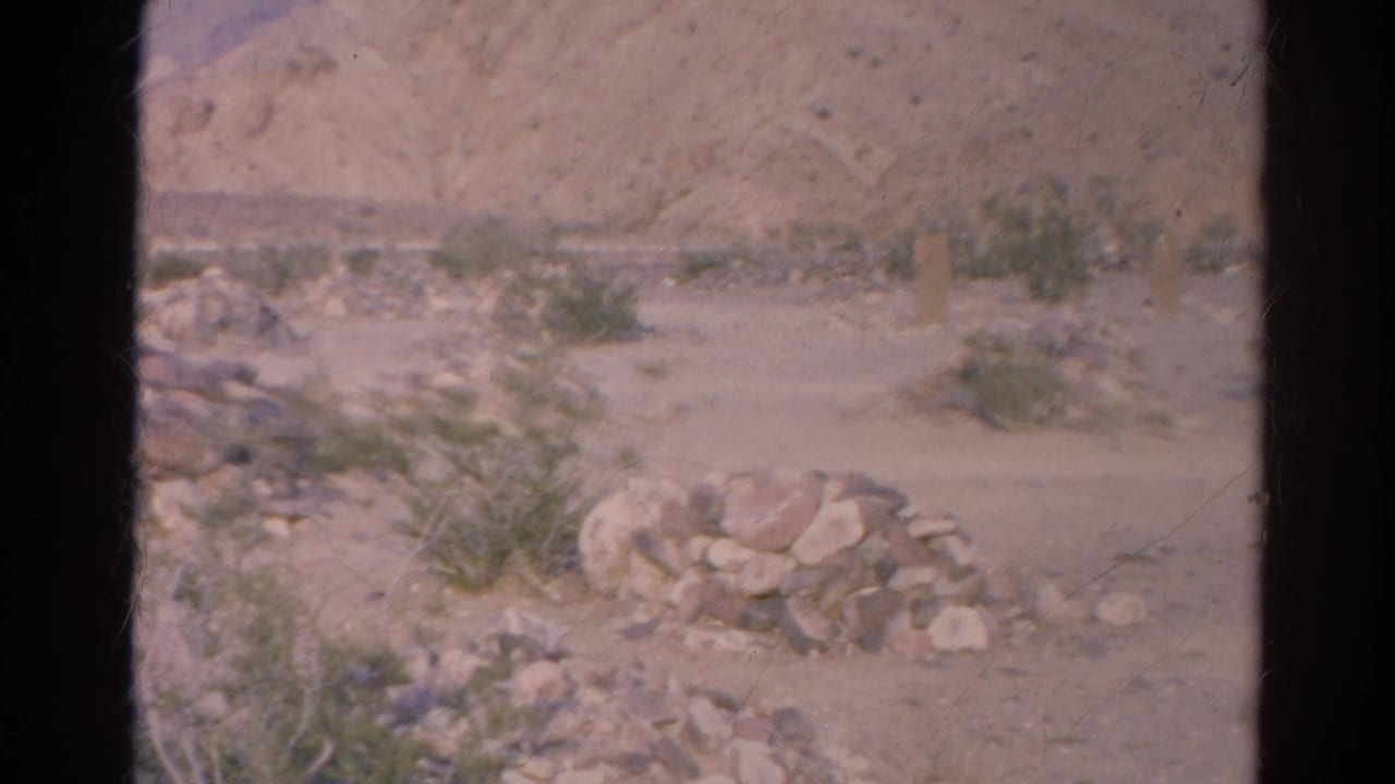 1966 Silver Lake footage appears to show a dry rocky site with a foreground stone pile, sparse brush, a post, and distant pale hills.