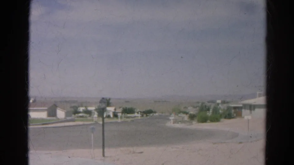 Silver Lake residential street scene from 1966 showing a paved cul-de-sac, low homes, posts, sparse yards, and muted sky.