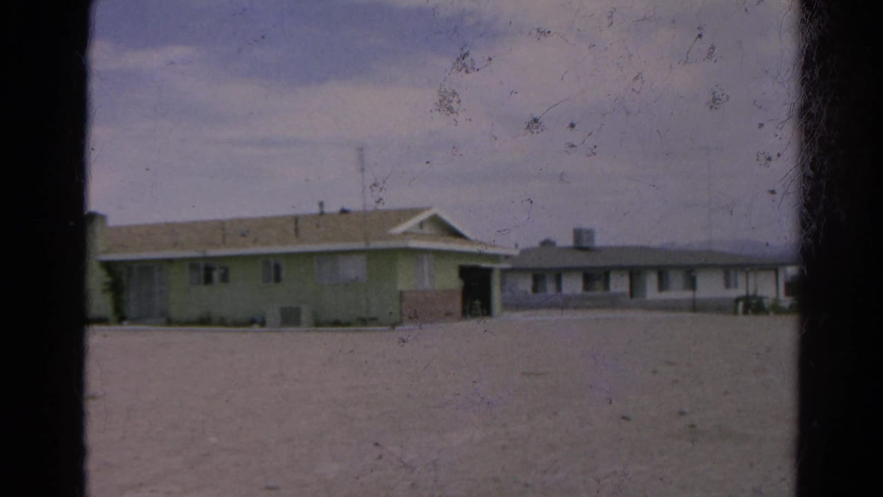 Silver Lake, California home-movie frame showing a low pale building and annex across a dusty open lot in 1966.