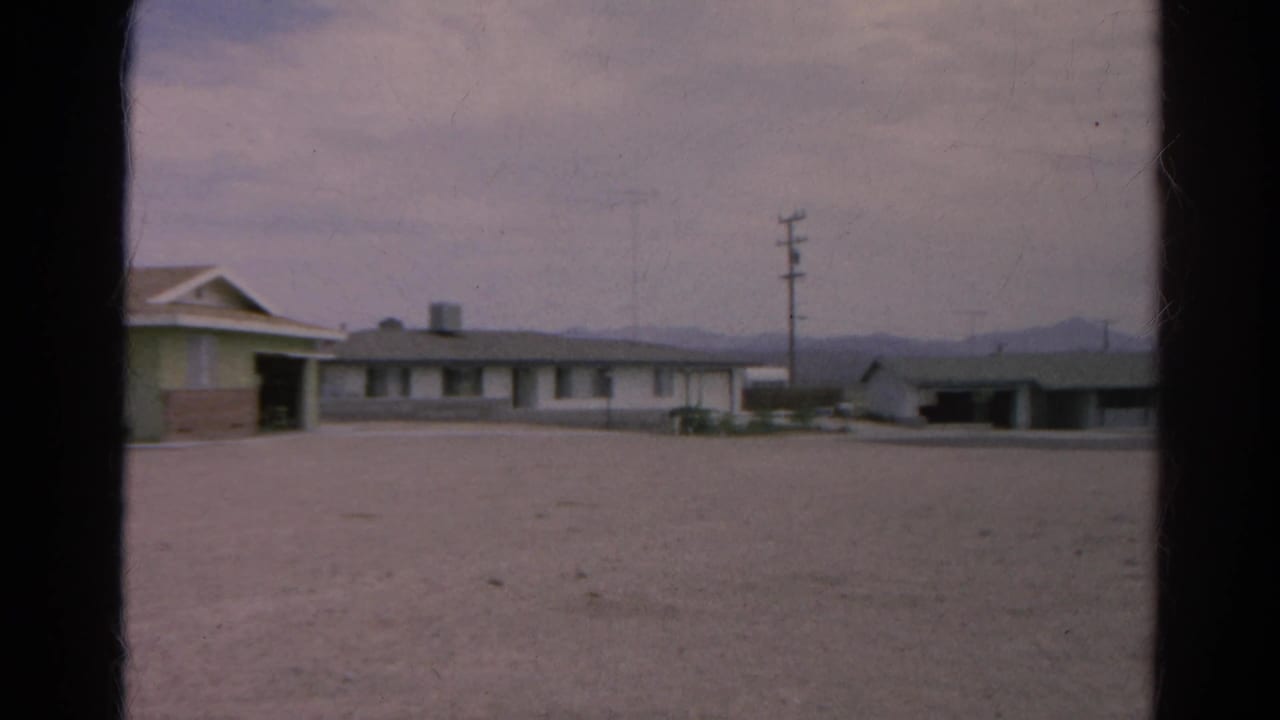 Silver Lake, California 8mm frame showing the motel-like complex edge, utility pole, open lot, and distant mountains in 1966.
