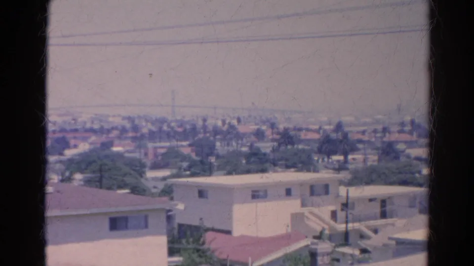 1966 Silver Lake-area view over low-rise homes, rooftops, palms, and overhead wires seen from a high vantage point.