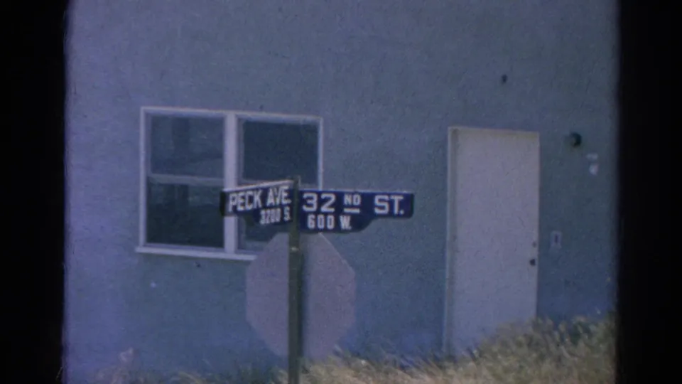 1966 Silver Lake street corner with Peck Ave and 32nd St signs in front of a simple light-colored building.