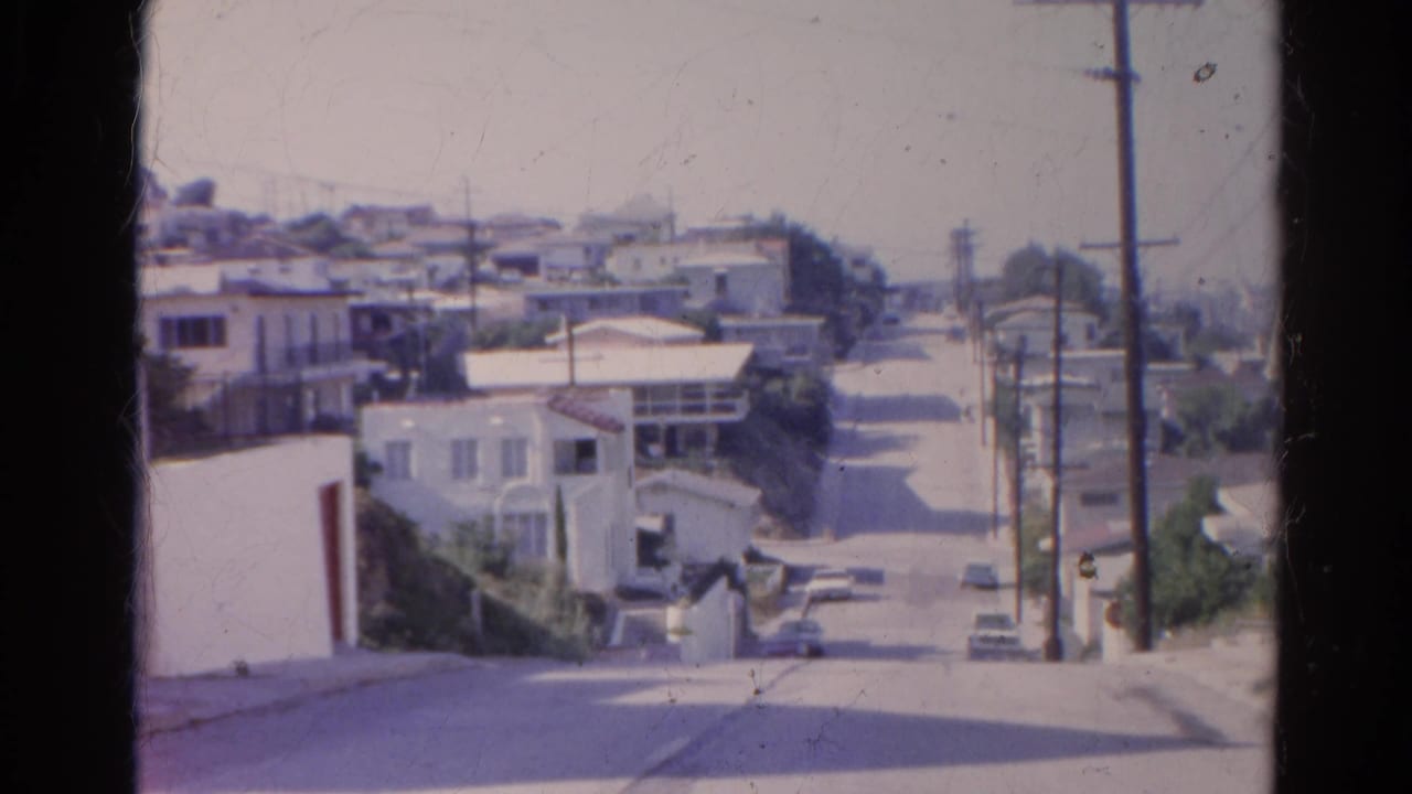 Silver Lake, California street view from 1966 showing hillside homes, parked cars, utility poles, and a quiet sunlit road.