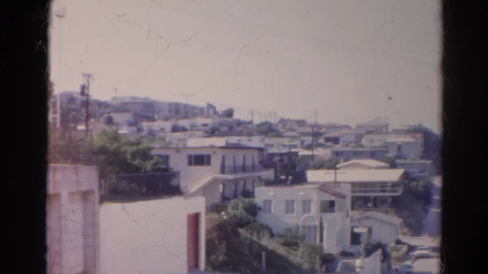 A slightly wider 1966 view across Silver Lake homes, vegetation, utility poles, roofs, and distant hillside.