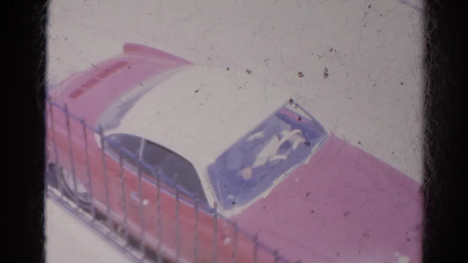 A clearer 1966 Silver Lake frame shows the two-tone red and white car beside a fence, with windshield glare and visible film wear.