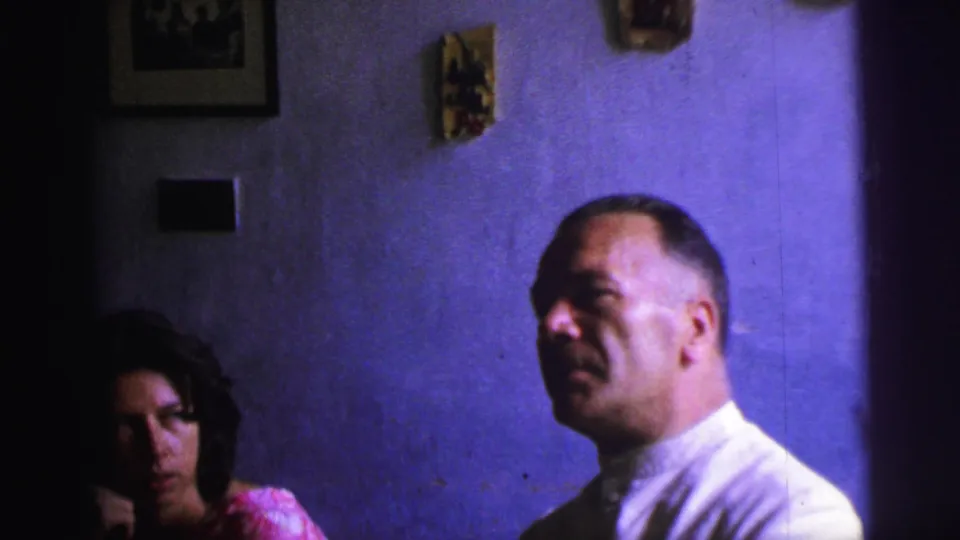 1967 Brazil 8mm still showing the man in a white shirt looking upward, with the woman partly shadowed at the edge of the frame.