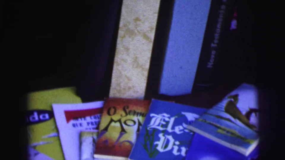 Soft 8mm frame from Brazil in 1967 with Bible spines, religious pamphlets, and visible Portuguese text.
