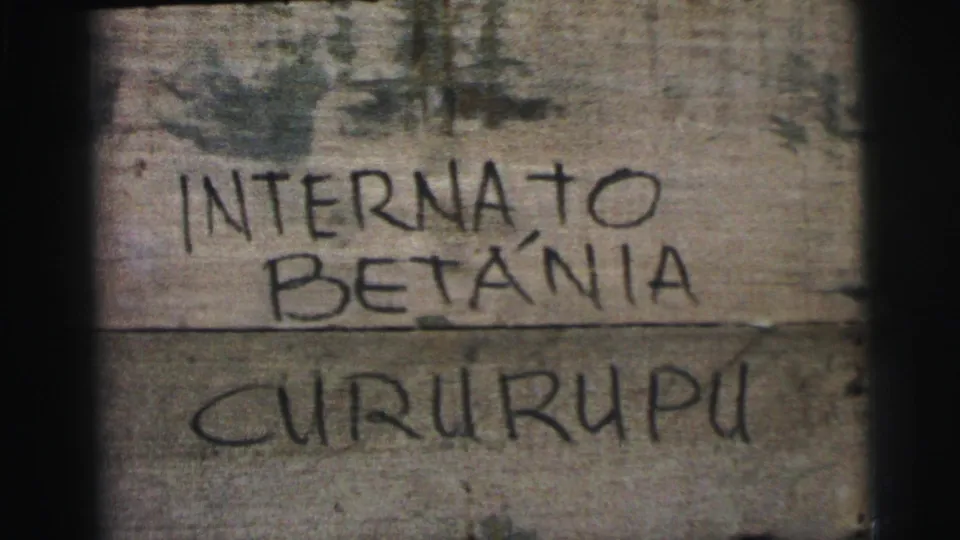 1967 Brazil 8mm close-up of the handwritten Internato Betânia Cururupu wording across rough wooden boards.