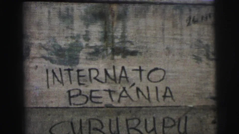 Close 8mm frame of the weathered Internato Betânia Cururupu sign, with faded color and dark frame edges.