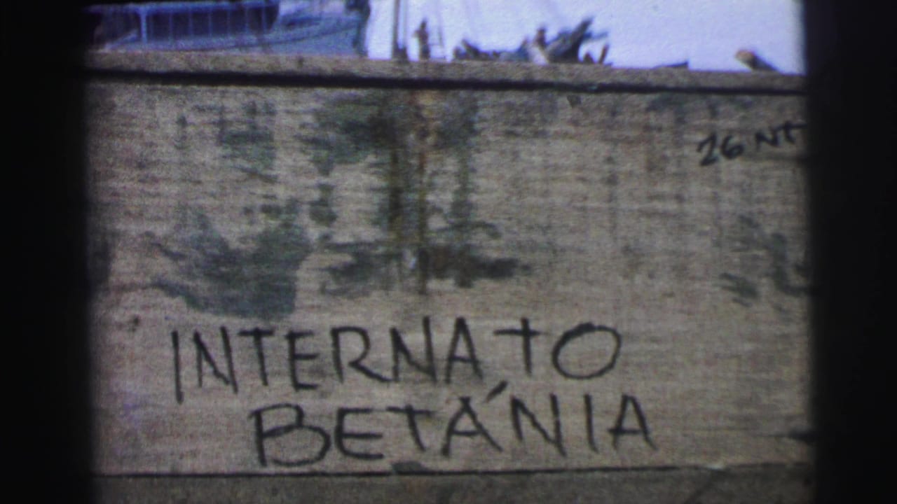 Weathered wall with handwritten “INTERNATO BETÂNIA” and a boat partly visible above it.
