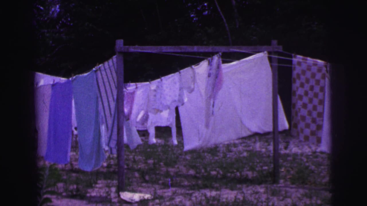 1967 Brazil home-movie view of outdoor laundry, including sheets and patterned fabric on a line in a yard.