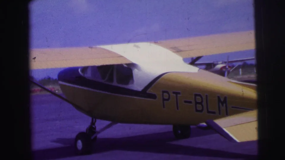 The yellow and blue aircraft shows PT-BLM registration on its side while taxiing on a Brazil runway in this 1967 8mm frame.