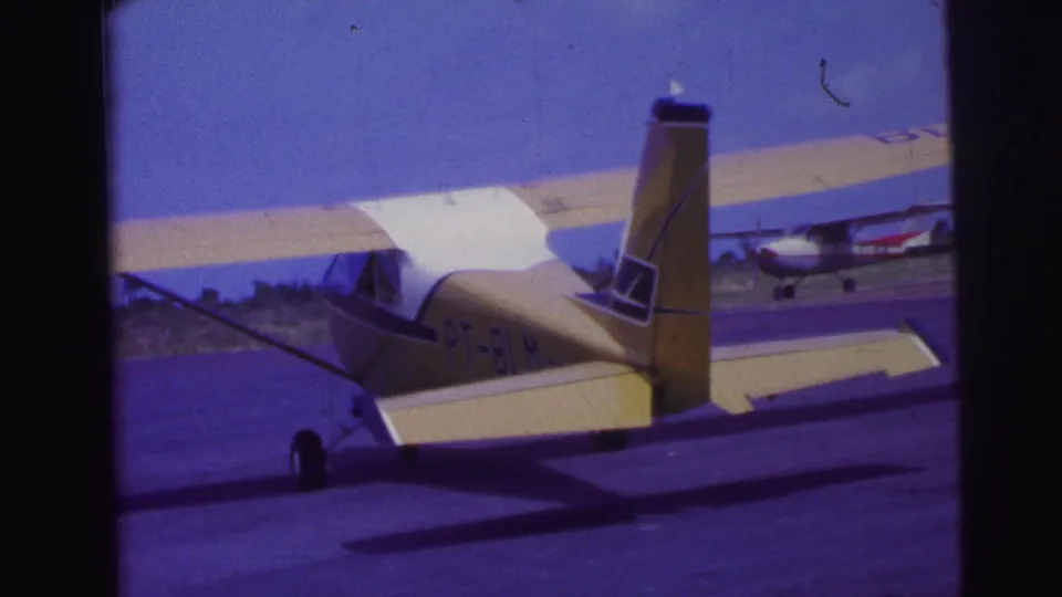 1967 Brazil home-movie frame showing the rear side of the PT-BLM aircraft as it continues along the runway.