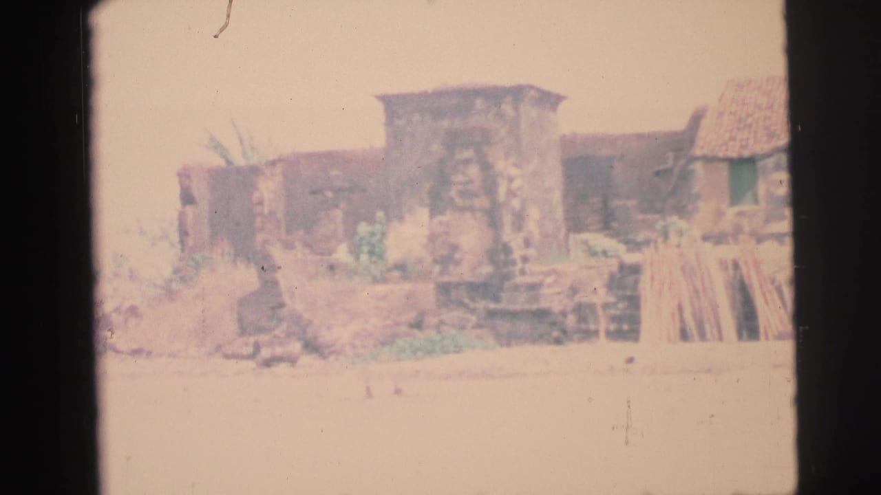 Weathered stone structure and shore seen through a film frame border.