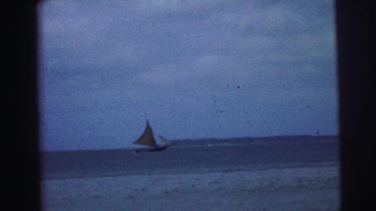 Small sailboat on blue water beneath a cloudy sky, framed by dark 8mm borders.