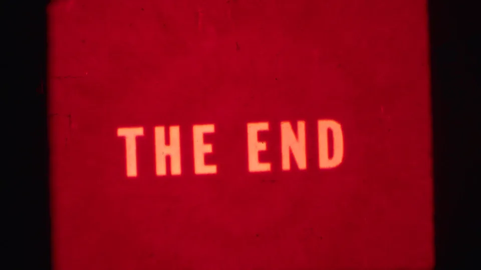 Red 8mm home-movie end card with bright block lettering reading THE END.