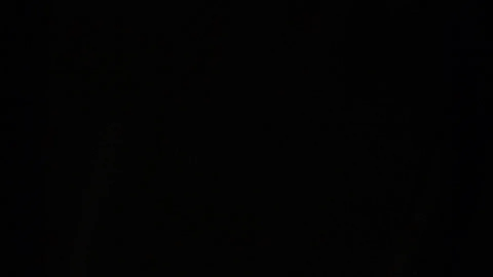 Dark-framed 1967 8mm view from a moving vehicle approaching the Mesa Verde National Park entrance area in Colorado.