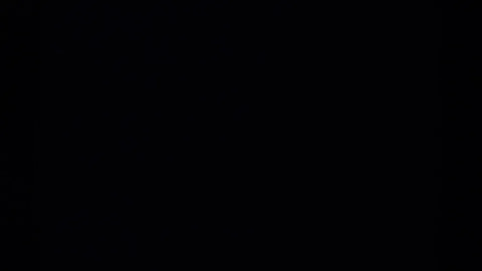 Mostly dark 8mm frame area from the 1967 Colorado clip, with only limited landscape detail visible at the edges.