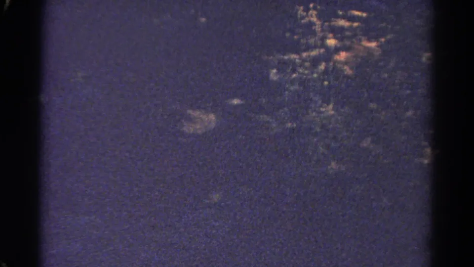 1967 Colorado 8mm frame showing wooded hills in a dark blue-purple cast with visible film edges.