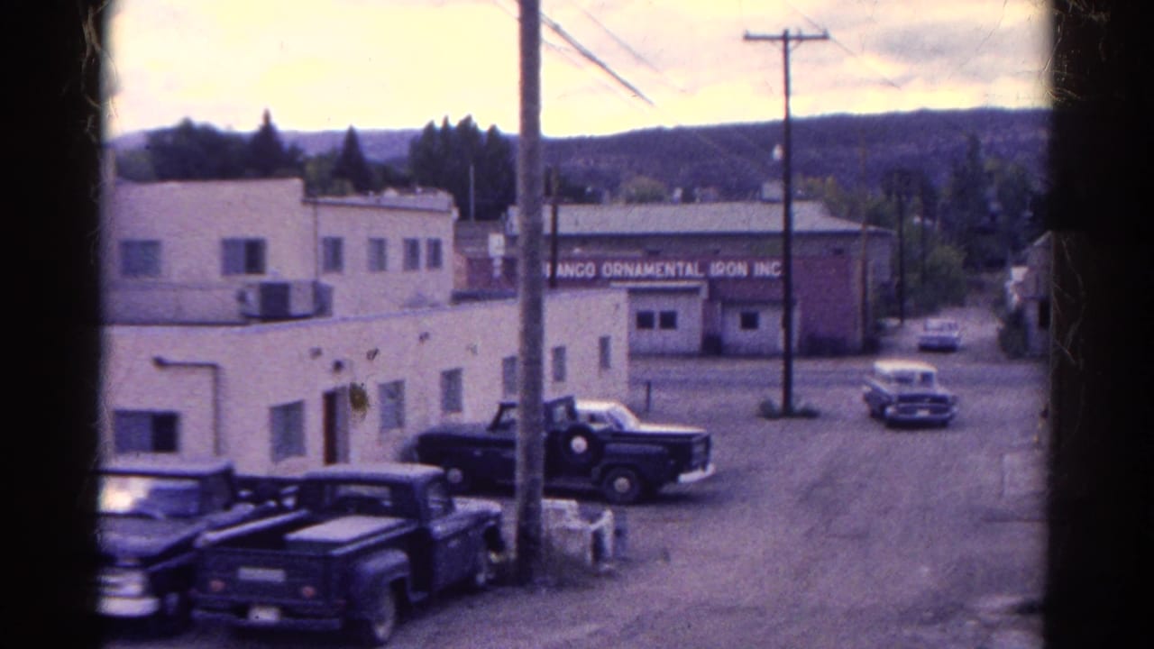 1967 Colorado street view with mid-century cars, utility poles, low industrial buildings, and a readable Durango Ornamental Iron Inc. sign.
