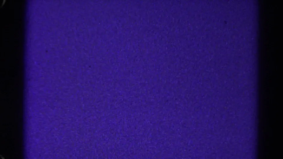 1967 Colorado 8mm frame showing a violet textured film field, dark edge borders, grain, and a black vertical divider.