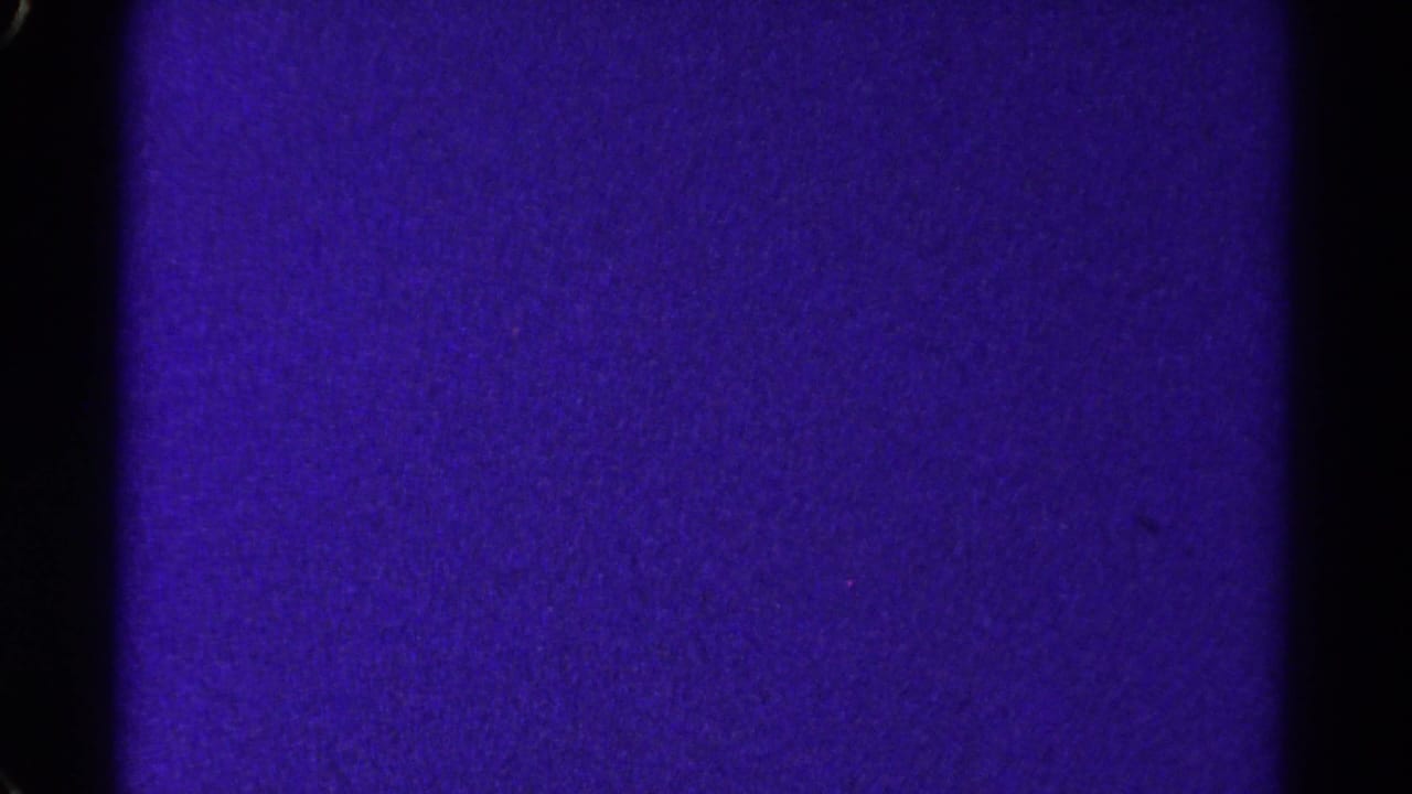 A purple 8mm home-movie frame from the 1967 Colorado reel, divided by a dark vertical gate edge and covered with visible grain.