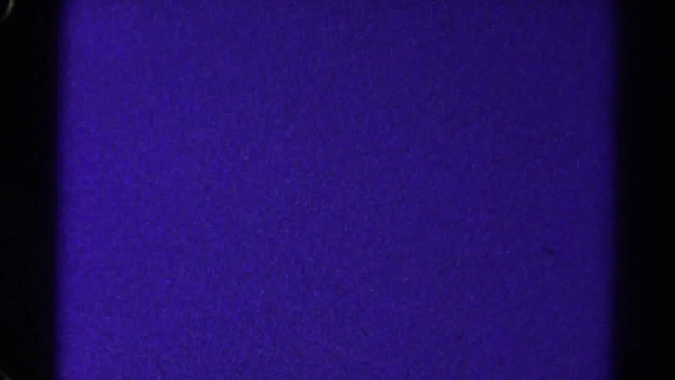 A purple 8mm home-movie frame from the 1967 Colorado reel, divided by a dark vertical gate edge and covered with visible grain.