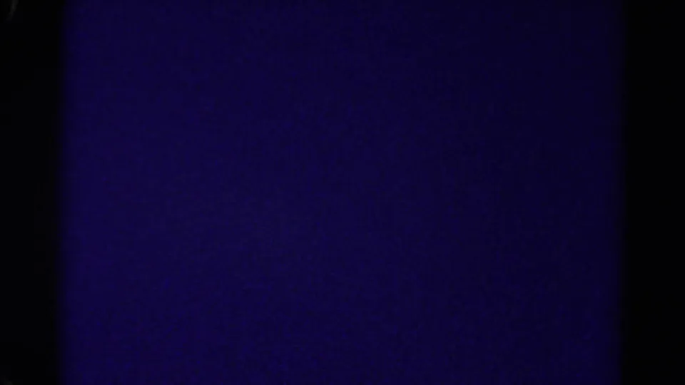 Dark purple 8mm transition frame, likely between exterior shots in the Colorado home movie.