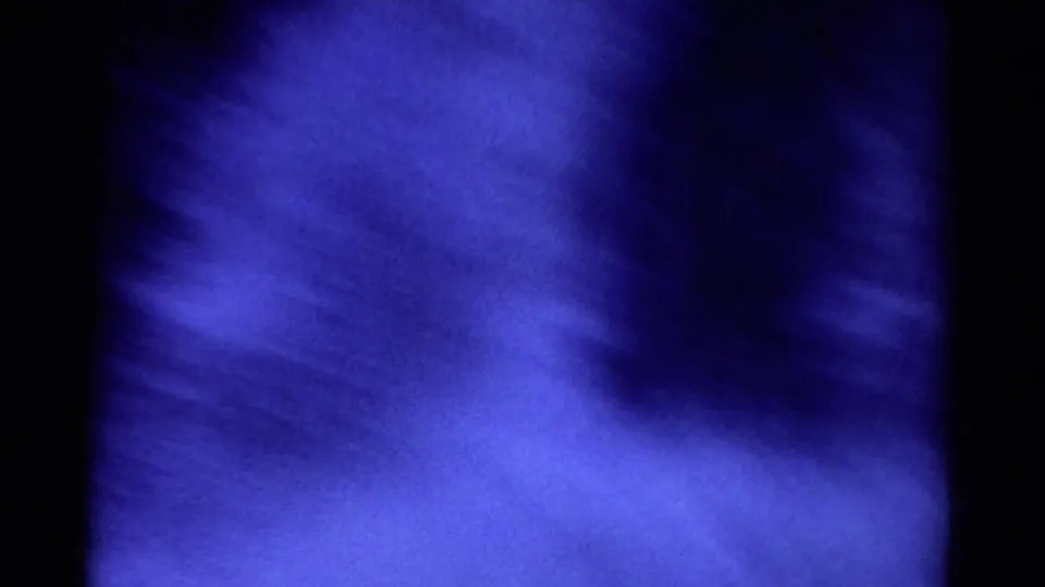 1967 Colorado 8mm frame showing soft, foamy blue water movement with dark shadows and a heavily grained film surface.