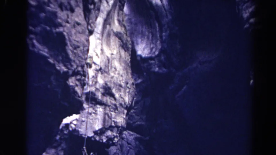Upward 8mm view of a Colorado canyon wall, with rope lines visible against sunlit and shadowed rock.
