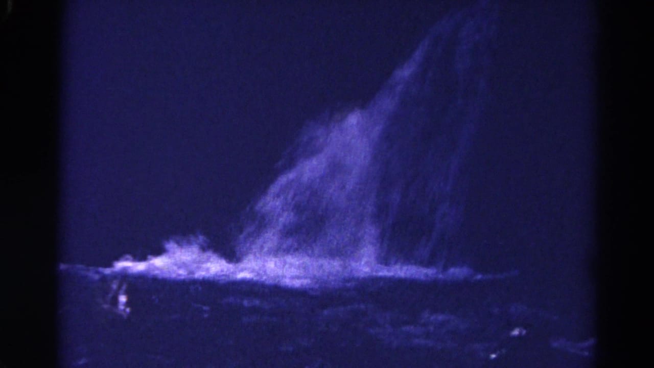 1967 Colorado 8mm frame showing water spilling across dark rock, with blue color shift and deep shadow.