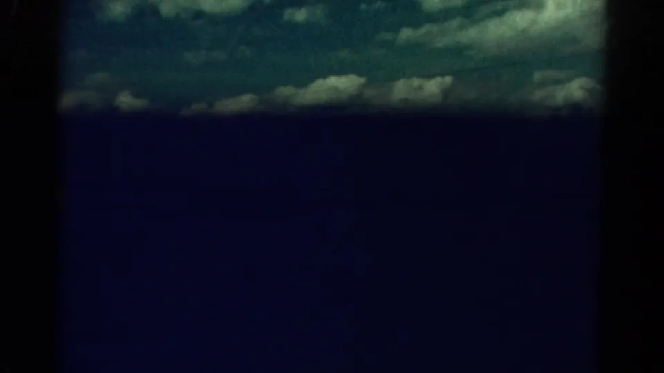 The 1967 Colorado 8mm view drops into deep blue darkness with only a strip of clouded sky remaining visible.