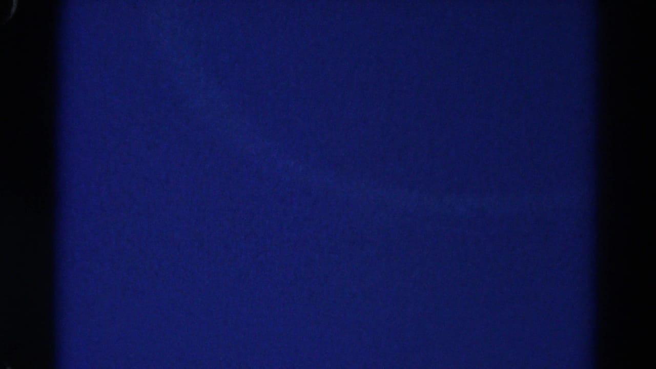 1967 Colorado 8mm frame showing mostly blue overexposed sky or blank exposure with dark film edges.