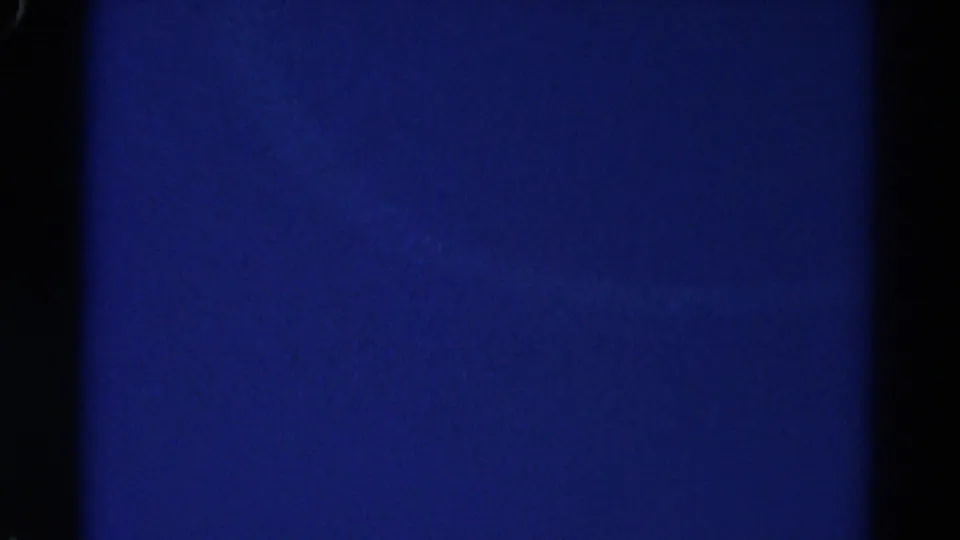 1967 Colorado 8mm frame showing mostly blue overexposed sky or blank exposure with dark film edges.