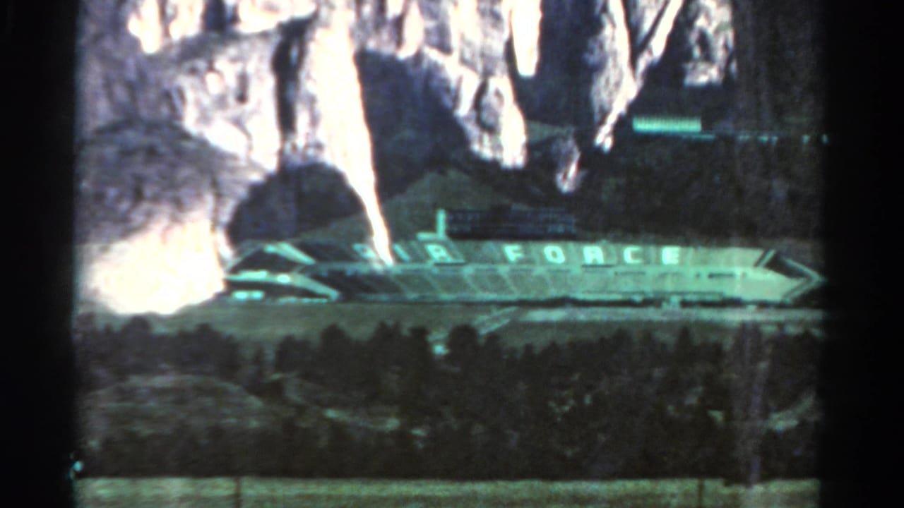 Stadium with AIR FORCE lettering seen below pale rock formations.