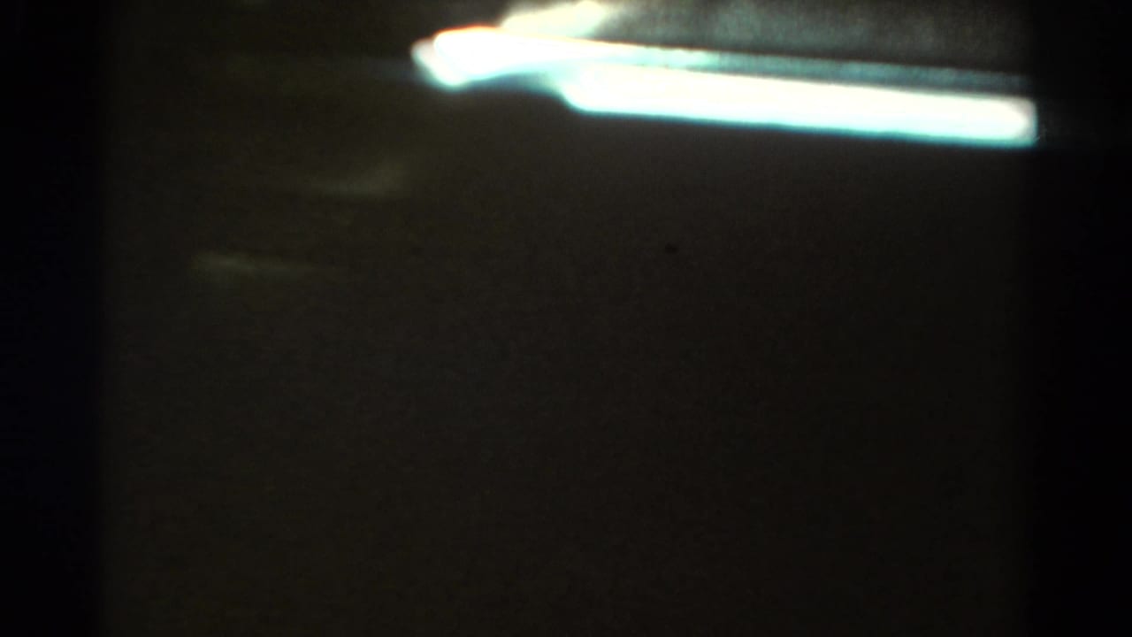 Opening 1967 Colorado 8mm frame with dark interior or frame edge obscuring much of the passenger-window view.