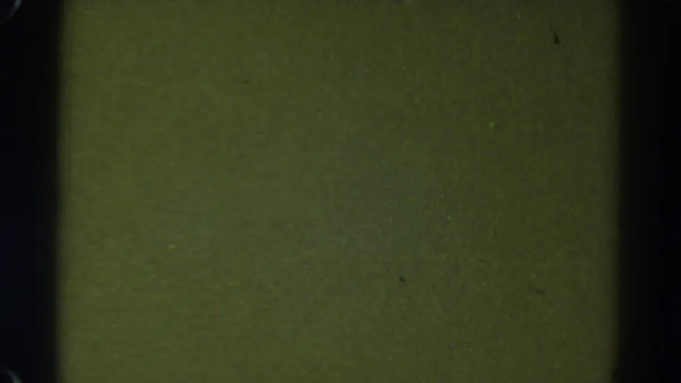 1967 Colorado 8mm frame showing a green blank area with dark border shadows, visible grain, and minor surface marks.