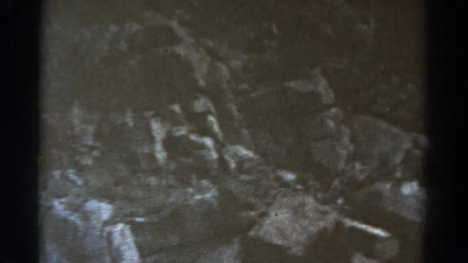 1967 8mm Colorado travel footage begins with a dim, grainy textured view framed by dark film edges.
