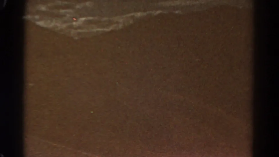Opening 8mm frame with dark film borders and a largely obscured brown area before the Royal Gorge entrance view appears.